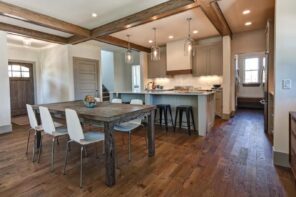 Top 7 Amazing Ideas for Refinishing Your Wooden Floor. Chalet style dining room with brutal wooden table and open massive ceiling beams