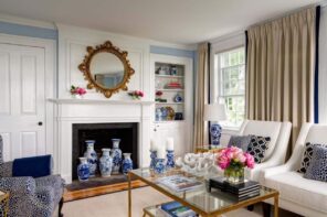 Unique Gifts for an Artist's Home: The most Memorable Ideas. Blue painted vases at the fireplace at the classic living room with the mirror and glass coffee table