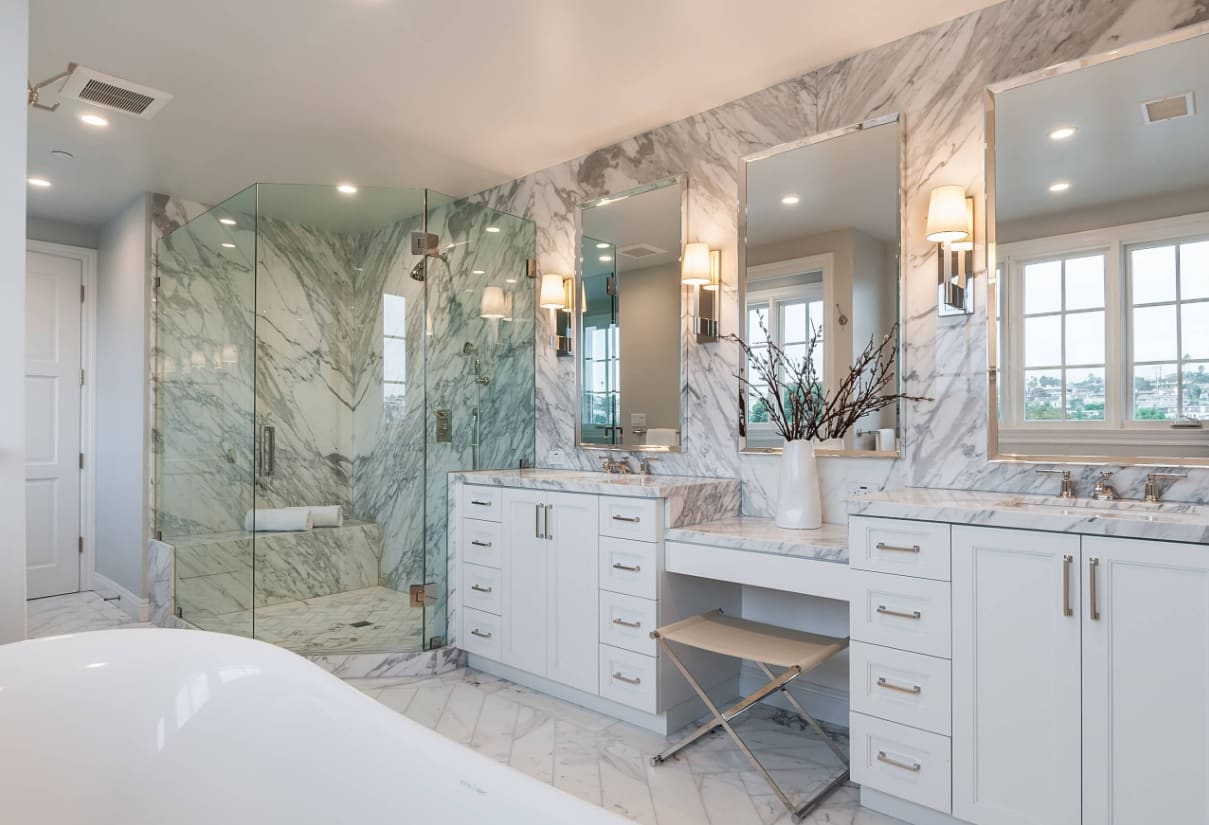 How a Bathroom Renovation can Add Personal & Monetary Value to Your Home. Chic classic interior with white furniture and noble streaked light gray marble at the walls