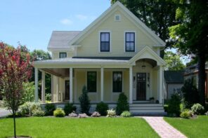 5 Popular Exterior Home Projects for Spring. Classic English style house with trimmed lawn in front