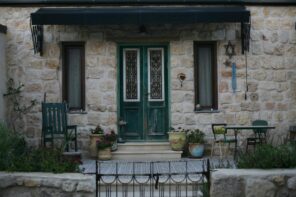 Looking For a Patio Door Replacement? Here Are Some Useful Tips. Stone cladded facade of the Classic French styled house with small paved porch and the canopy at the door