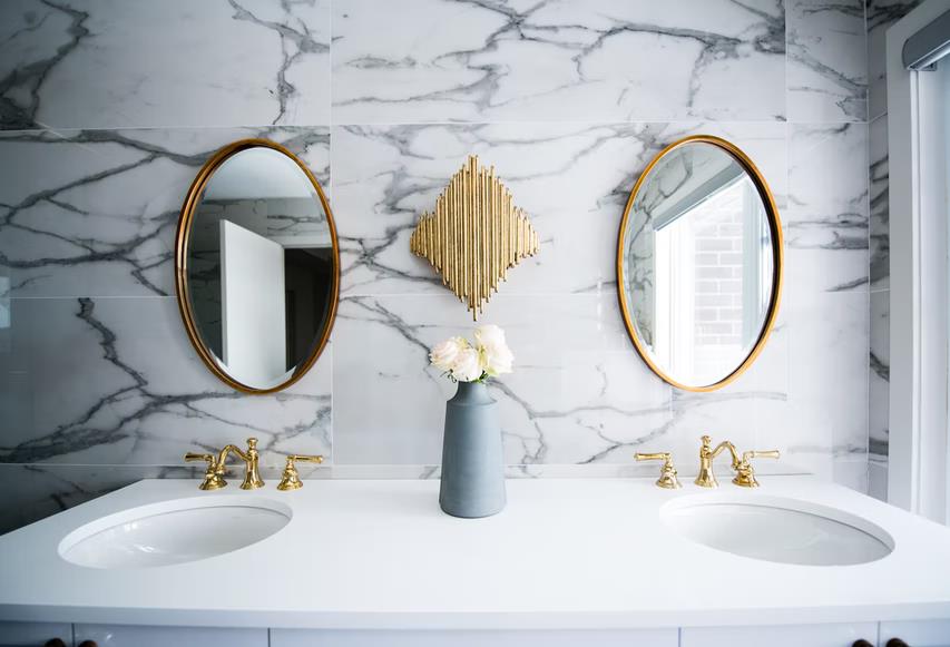 Decided To Renovate Your Bathroom? These Simple Tricks From Strip Drain Will Help You. Marble trimmed space and formed vanity for two with golden taps
