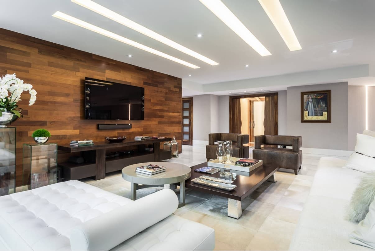 What is Interior Design and How Does it Affect Mental Health? Large spacious living room with modern style and wooden accent wall with TV-panel