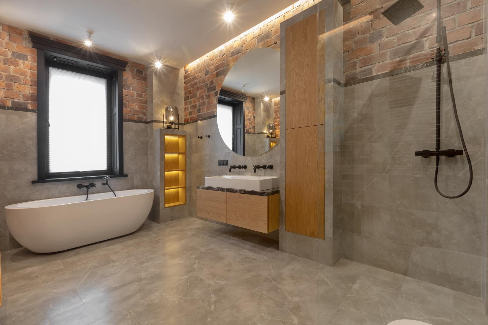 5 Reasons To Choose An Open Shower Design. Brickwork top level and faux concrete wainscoting as well as concrete floor in the modern industrial bathroom with complex lighting