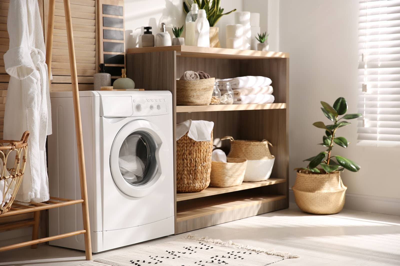 6 Laundry Room Design Ideas And Tips. Casual interior with storage and small washing machine and plant making living atmosphere