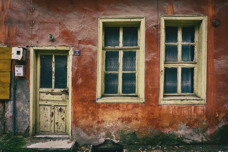 4 Care Tips for Old Or Antique Windows. An old abandoned house with crackled painted walls