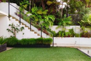How To Redesign Your Garden And Make It More Comfortable. Neat trimmed grass and shrubs at the stairs to the top level