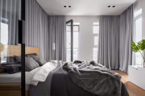 Ways to Stay Cool in Your Apartment During the Summer Months. Gray toned design of the bedroom with thick insulating curtains