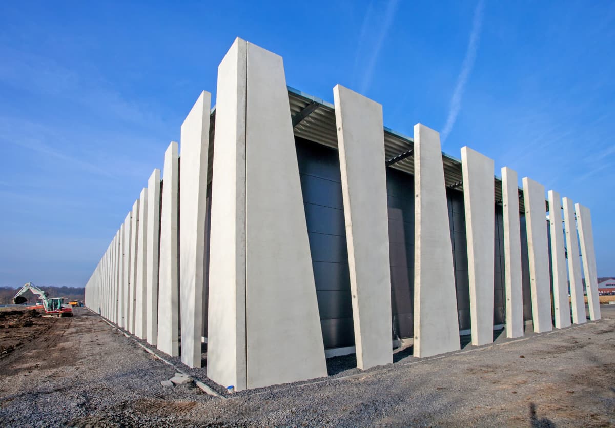 Sustainable Building Materials for an Eco-Friendly Home. Ultramodern precast concrete and glass design of the building