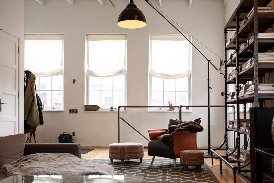 Loft Styling Tips for Better Living. High ceilings and creative minimalism for man's cave with large simple curtained windows