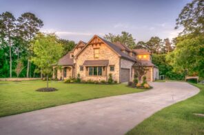 4 Outdoor Home Improvement Tips That Add Long-Term Value. The suburb mansion in sandy color and modern version of English Colonial style