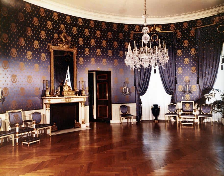 The Different Types Of Wallpaper And How To Choose. Royal interior design with the fireplace, crystal chandelier in the center and dark silky empossed wllpaper