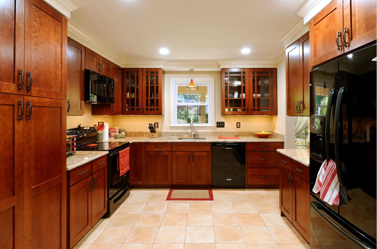 Some Great Custom Designed Storage Solutions to Amp up Your Cabinets. Laquered dark alder wood furniture and black appliances shine in top spotlighting